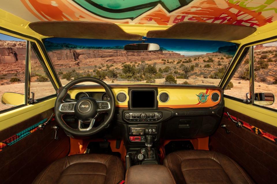 <p>Mixing old and new inside the Cherokee concept, Jeep continues the brightly colored theme but retrofits interior bits from the modern Wrangler. The transplanted parts include the entire dash, the center console, and the seats covered in handsome brown leather.</p>