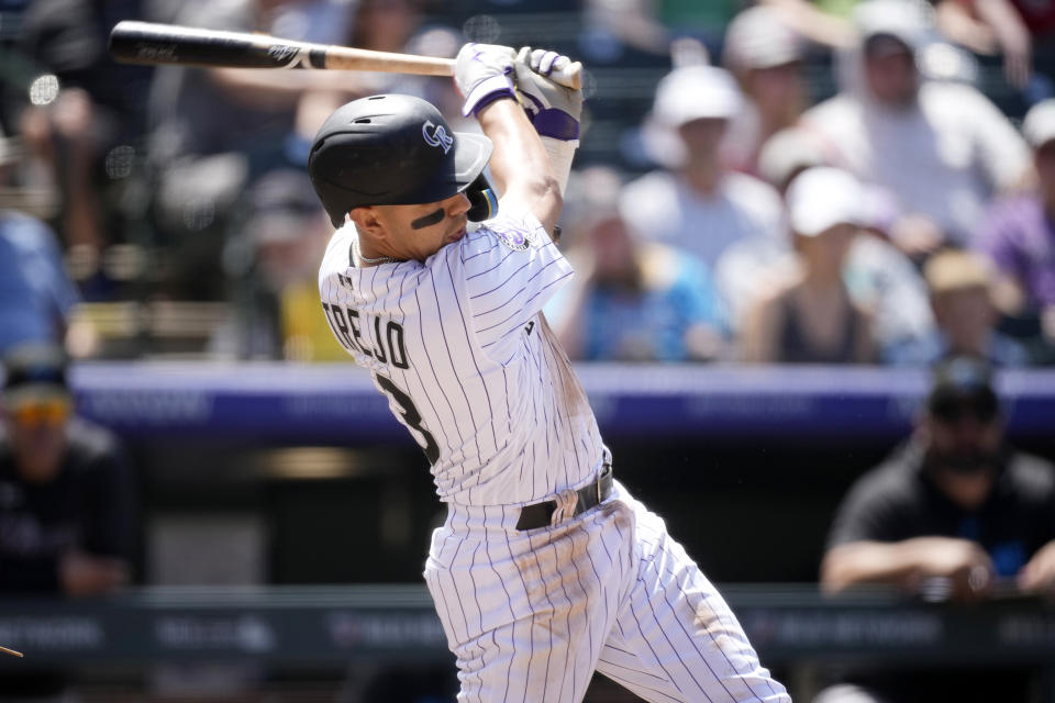 Colorado Rockies' Alan Trejo singles to drive in a run off Miami Marlins starting pitcher Braxton Garrett in the fourth inning of a baseball game Thursday, May 25, 2023, in Denver. (AP Photo/David Zalubowski)