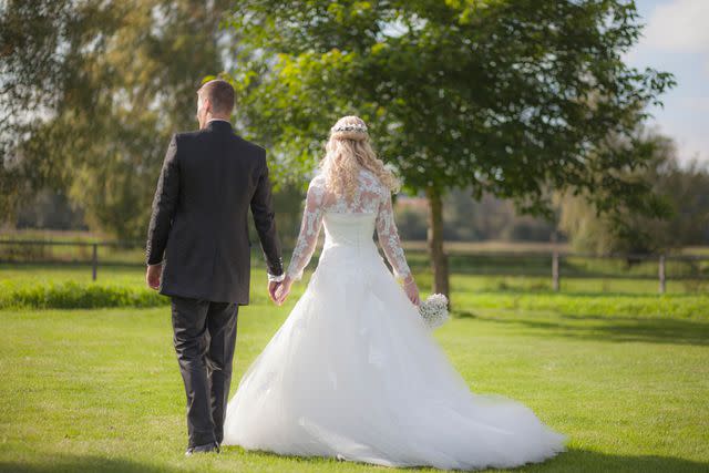 <p>Getty</p> A couple stands together on their wedding day