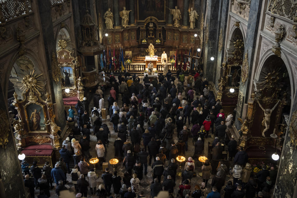 Christian worshippers attend a Sunday mass in the Saints Peter and Paul Garrison Church in Lviv, western Ukraine, Sunday, March 6, 2022. (AP Photo/Bernat Armangue)