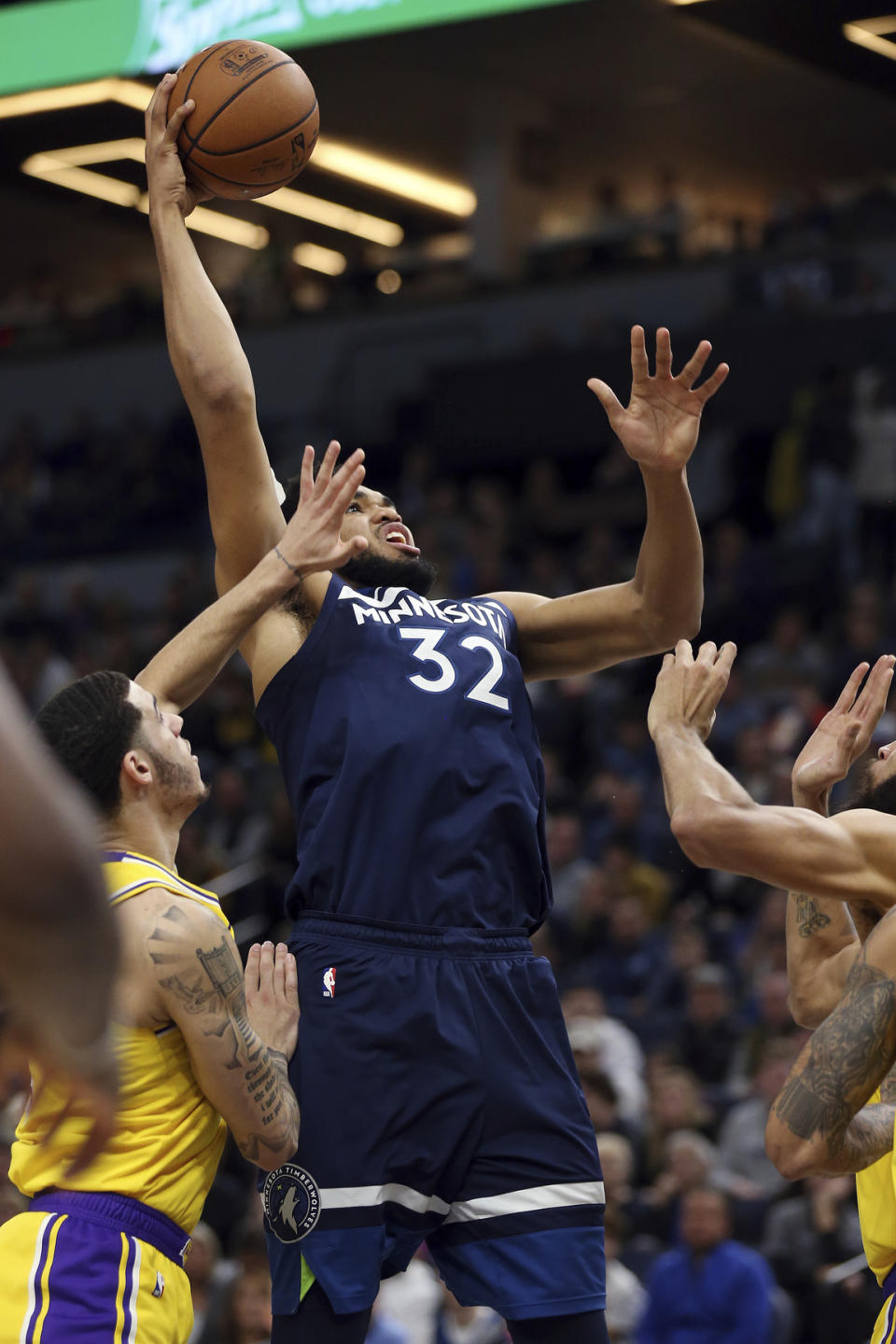 Minnesota Timberwolves' Karl-Anthony Towns shoots the ball over Los Angeles Lakers' Lonzo Ball in the first half of an NBA basketball game Sunday, Jan. 6, 2019, in Minneapolis. (AP Photo/Stacy Bengs)