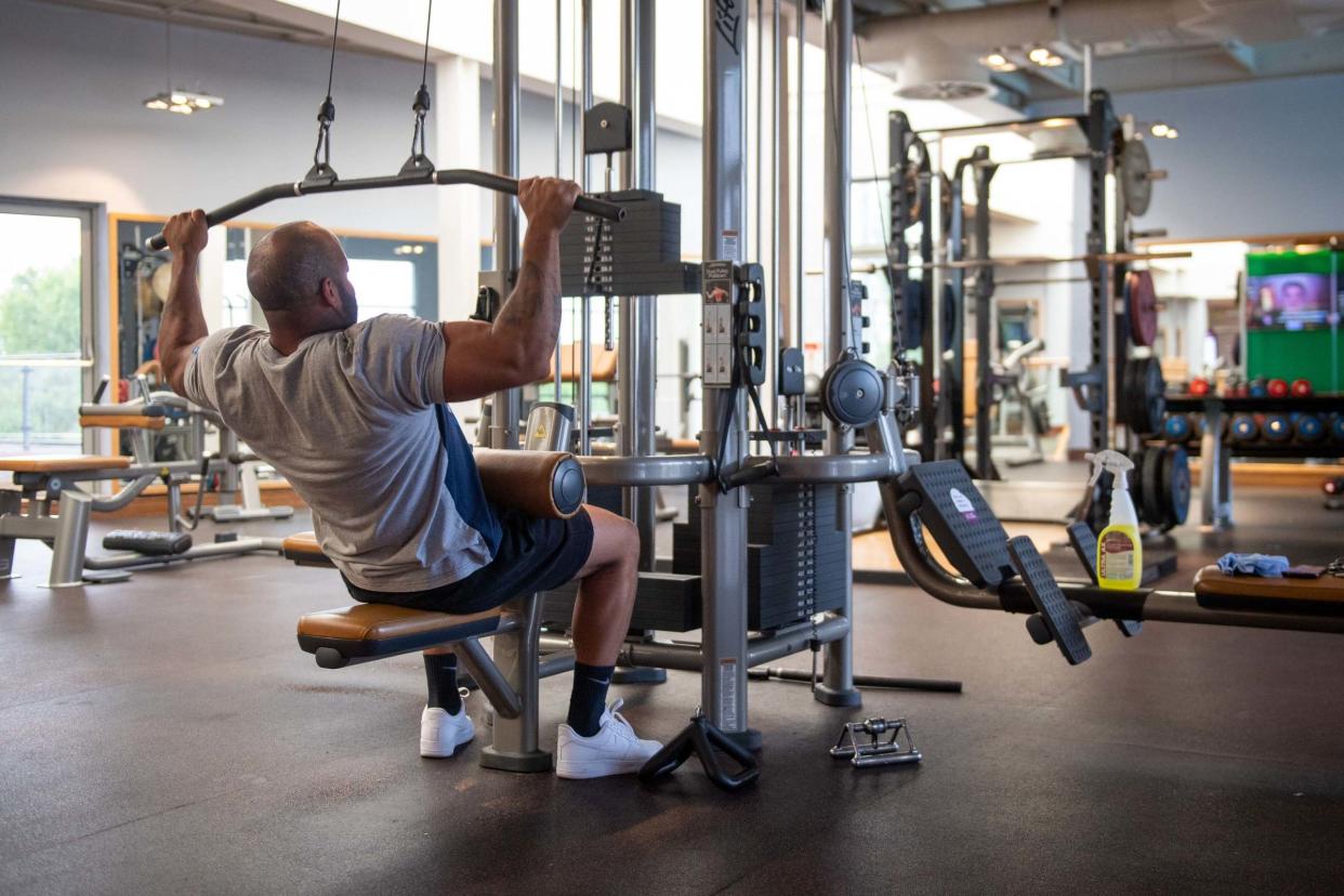 A gym member works out at David Lloyd in Cambridge: PA