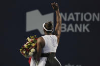 Serena Williams, of the United States, leaves the court while carrying flowers and waving to fans after her loss to Belinda Bencic, of Switzerland, during the National Bank Open tennis tournament Wednesday, Aug. 10, 2022, in Toronto. (Chris Young/The Canadian Press via AP)