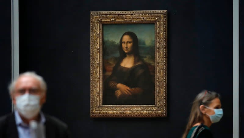 Journalists walk past Leonardo da Vinci's "Mona Lisa" during a visit of the Louvre museum in Paris, Tuesday, June 23, 2020. Renovation plans at the museum involve moving the painting into a separate room below ground.