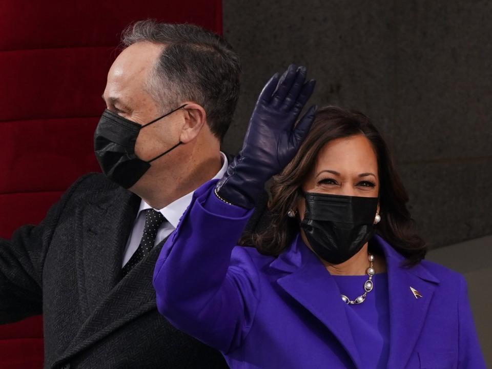 Vice-president elect Kamala Harris and her husband Doug Emhoff wave as they make their entrance to the inaugural ceremony on the West Front of the CapitolREUTERS