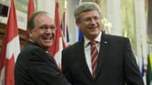 Prime Minister Stephen Harper welcomes Bernard Valcourt at the start of caucus meetings in Ottawa in June.