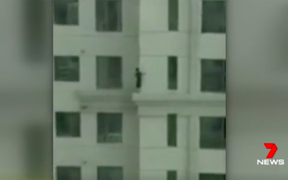 Two children ‘play’ on the ledge of a 33-storey apartment block. Source: 7 News