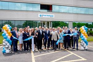 Christopher Becker, President and CEO cuts the ribbon on First National Bank LI’s newly relocated Hauppauge location in celebration with team members and loyal customers. Pictured front row left to right: Robert Grady, SVP Director of Middle Market Lending, Carrie Genoino, First VP Director of Marketing and Public Relations; Angela Reese, SVP Branch District Manager; JoAnn Diamond, VP Branch Manager; Cristofer Damianos, Principal at Damianos Realty Group; Christopher Becker, President and CEO; John J. Finn, Director of Leasing and Acquisitions at Damianos Realty Group; Margaret Curran, SVP Middle Market Team Leader; Chris Hilton, EVP Chief Lending Officer; Leonardo Tavera, SVP Corporate Planning Officer.