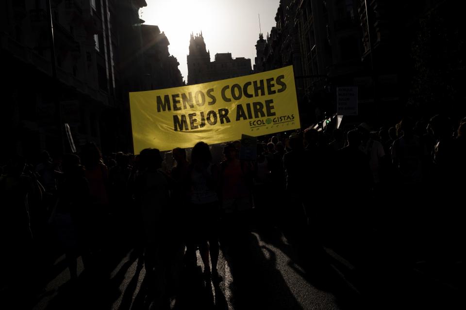 Citizens rally in favor of a low-emission zone policy and against the new city council in Madrid, Spain, Saturday, June 29, 2019. The new municipality has decided to overturn ¨Madrid Central¨, an environment policy that banned most diesel and petrol cars within Madrid's downtown. The banner reads in Spanish ¨Less cars, better air¨. (AP Photo/Bernat Armangue)