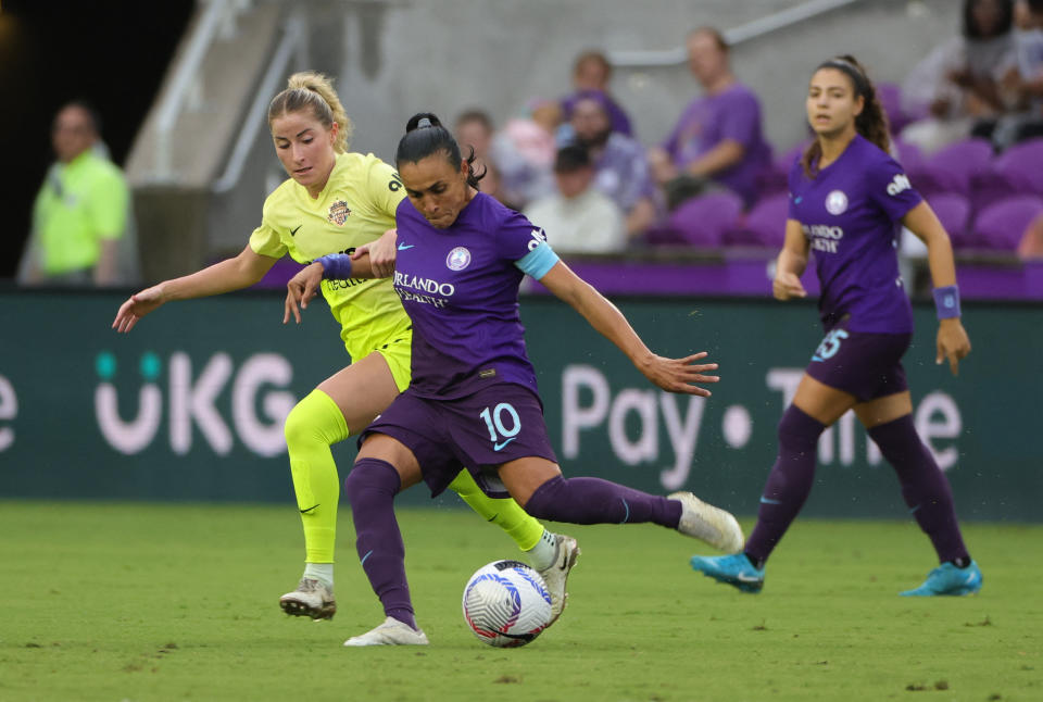 Oct 6, 2024; Orlando, Florida, USA; Washington Spirit midfielder Heather Stainbrook (22) and Orlando Pride forward Marta (10) battle for the ball in the first half at Inter&Co Stadium. Mandatory Credit: Mike Watters-Imagn Images