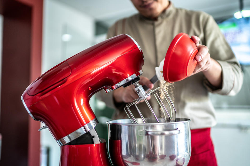 A man using a KitchenAid mixer