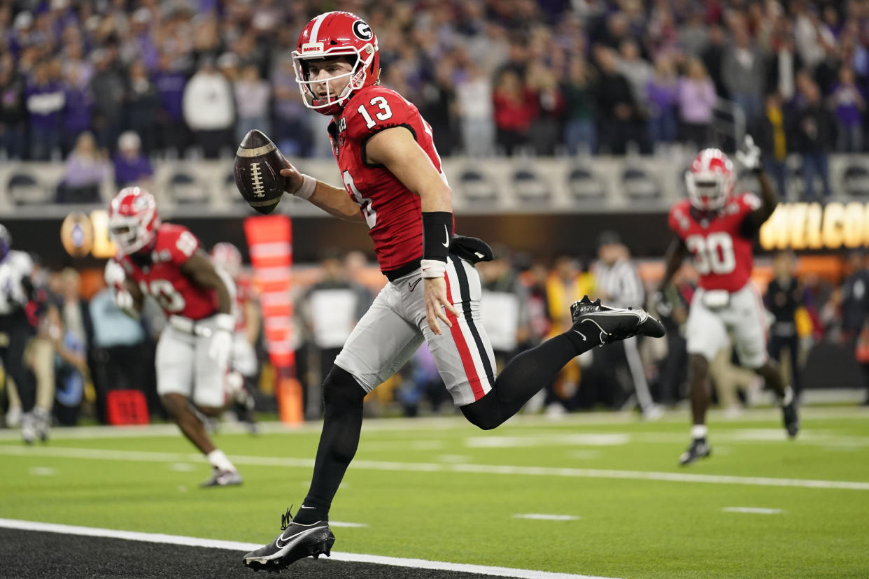 Georgia quarterback Stetson Bennett (13) runs into the end zone for a touchdown against TCU during the first half of the national championship NCAA College Football Playoff game, Monday, Jan. 9, 2023, in Inglewood, Calif. (AP Photo/Ashley Landis)