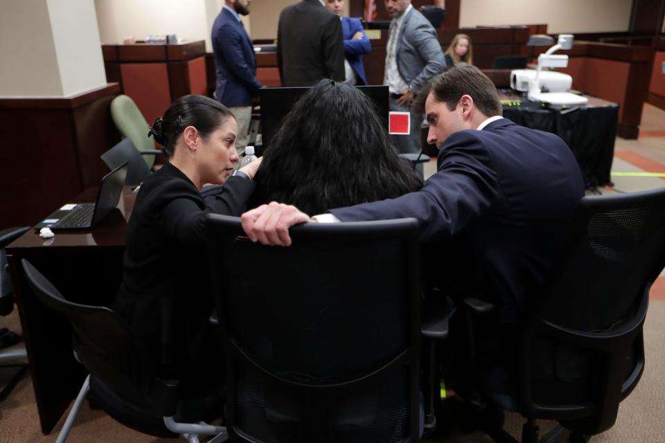 Chris DeCoste, attorney for Katherine Magbanua, comforts her as she sobs following a guilty verdict against her co-defendant and former longtime boyfriend Sigfredo Garcia.