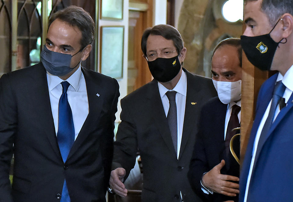 Cyprus President Nicos Anastasiades, center, Greece's Prime minister Kyriakos Mitsotakis, left, and Egypt's President Abdel-Fattah el-Sissi, center right, are seen before their meeting at the presidential palace in capital Nicosia, Cyprus, on Wednesday, Oct. 21, 2020. The leaders of Cyprus, Egypt and Greece meet in the Cypriot capital for talks on forging closer ties and boosting cooperation on issues including energy following the discovery of gas deposits in the east Mediterranean. (Iakovos Hatzistavrou Pool via AP)