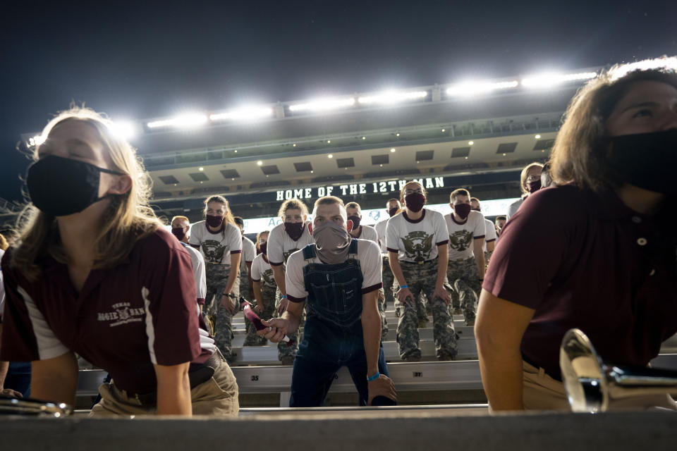 Members of the Texas A&M Corps of Cadets Band practice yells inside of Kyle Field, College Station, Texas as part of the first Midnight Yell Practice this season early Saturday, Sept. 26, 2020. . Due to Coronavirus restrictions, the band was the only crowd allowed in the normally packed stands for the traditional game day event in College Station, Texas. (Sam Craft/Pool Photo via AP)