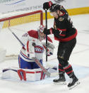 Ottawa Senators left wing Brady Tkachuk (7) tries to deflect a shot past Montreal Canadiens goaltender Cayden Primeau, left, during first-period NHL hockey game action in Ottawa, Ontario, Saturday, April 13, 2024. (Adrian Wyld/The Canadian Press via AP)