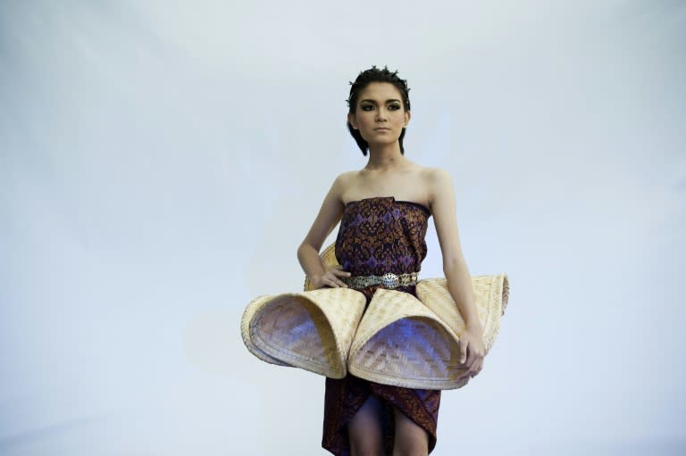 A model poses with a creation by Thai teen designer Apichet Atilattana, 16, at the Alliance Francaise in Bangkok