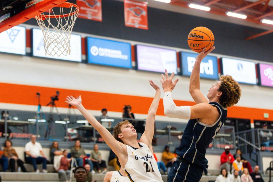 Crimson Cliffs High School’s Luke Johnson shoots the ball with Copper Hills High School’s Austin Ormond on defense during a boys basketball semifinal game of the Allstate Falcon Classic at Skyridge High School in Lehi on Friday, Dec. 8, 2023. | Megan Nielsen, Deseret News