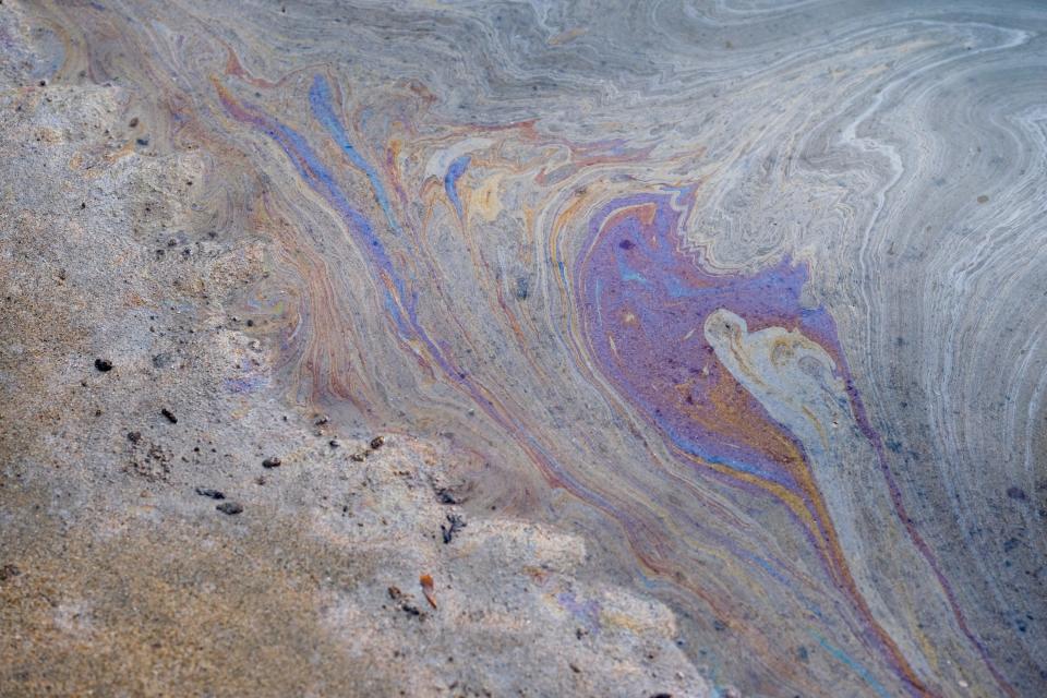Oil washes up on Huntington Beach on Oct. 4.