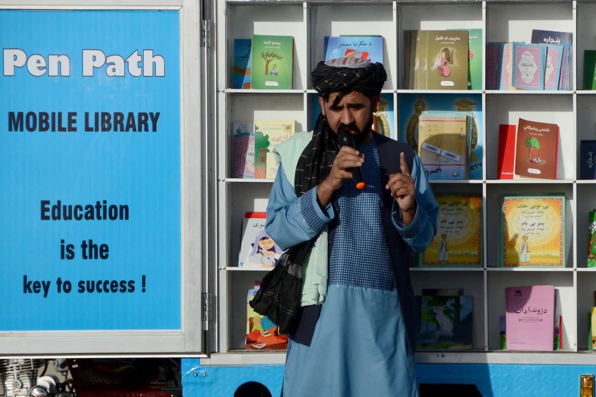 Matiullah Wesa, head of PenPath and advocate for girls’ education in Afghanistan, speaks to children during a class next to his mobile library in Spin Boldak district of Kandahar Province (AFP via Getty Images)