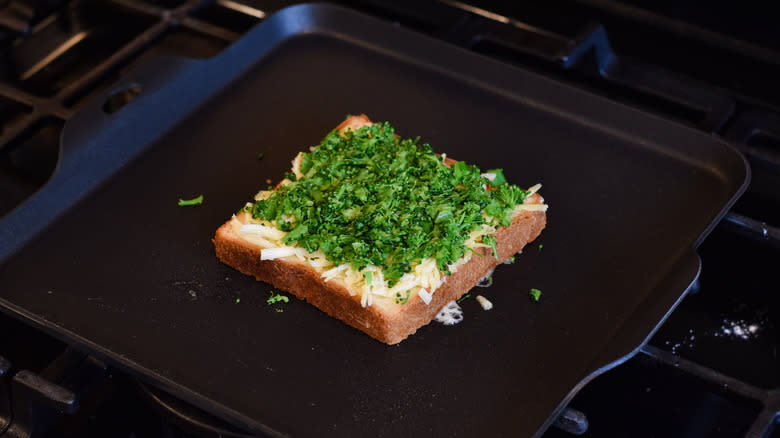 adding bread and cheese skillet