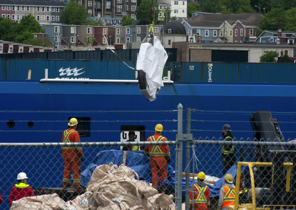 Debris from the Titan submersible, recovered from the ocean floor near the wreck of the Titanic, is unloaded from the ship Horizon Arctic at the Canadian Coast Guard pier in St. John's, Newfoundland, Wednesday, June 28, 2023. (Paul Daly/The Canadian Press via AP)