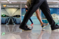 Passengers walk past a closed Thomas Cook office at Palma de Mallorca airport on Monday Sept. 23, 2019. Spain's airport operator AENA says that 46 flights have been affected by the collapse of the British tour company Thomas Cook, mostly in the Spanish Balearic and Canary archipelagos. (AP Photo/Francisco Ubilla)