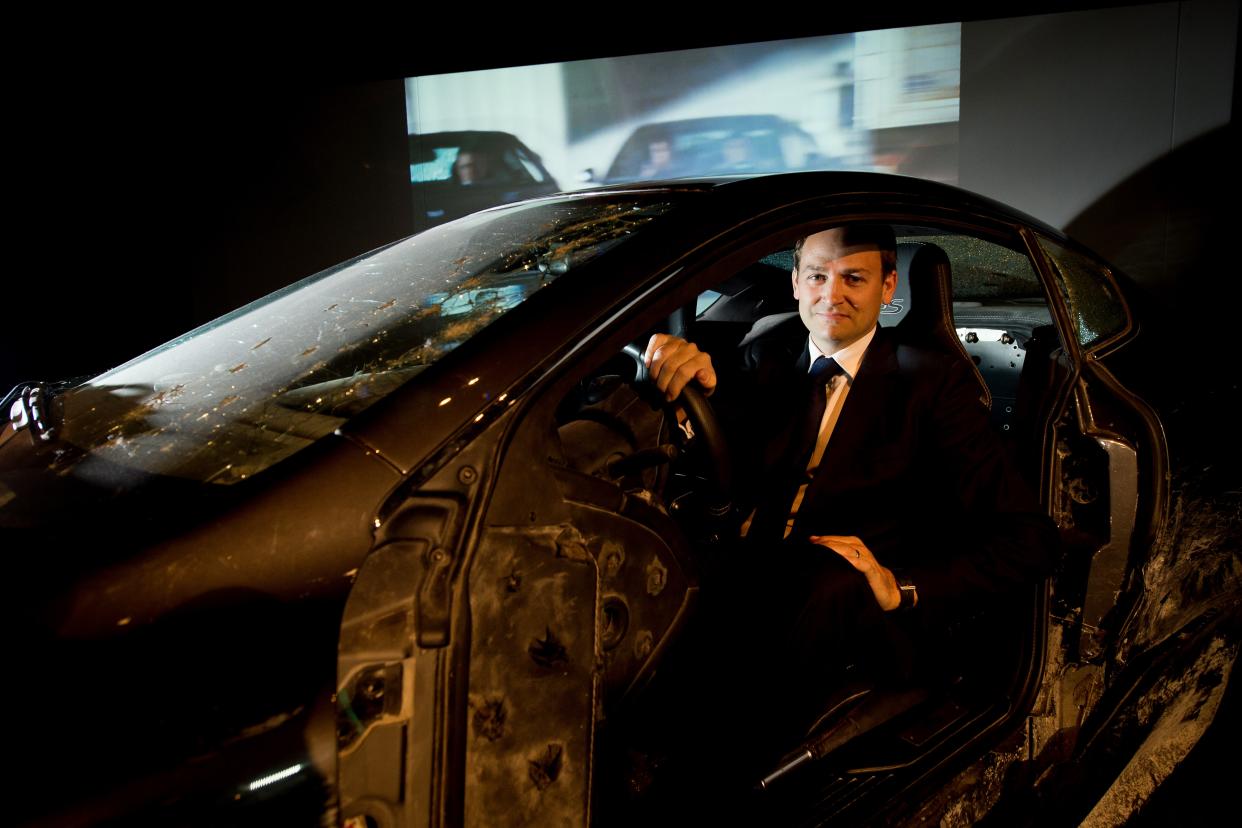 Stunt driver Ben Collins sits in one of the Aston Martin DBS cars that he used in the James Bond film 