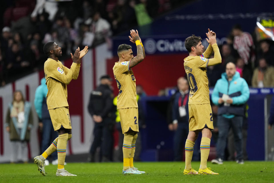 Barcelona's team players applaud after the Spanish La Liga soccer match between Atletico Madrid and FC Barcelona at Civitas Metropolitano stadium in Madrid, Spain, Sunday, Jan. 8, 2023. (AP Photo/Manu Fernandez)