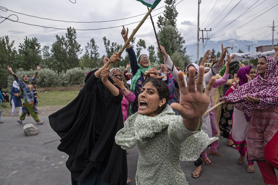 Women shout slogans as Indian policemen fire teargas and live ammunition in the air to stop a protest march in Srinagar, Indian controlled Kashmir, Aug. 9, 2019. The image was part of a series of photographs by Associated Press photographers which won the 2020 Pulitzer Prize for Feature Photography. (AP Photo/Dar Yasin)