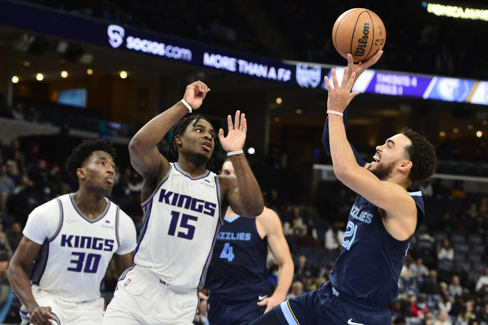 Memphis Grizzlies guard Tyus Jones (21) shoots against Sacramento Kings guard Davion Mitchell (15) in the second half of an NBA basketball game Sunday, Nov. 28, 2021, in Memphis, Tenn. (AP Photo/Brandon Dill)