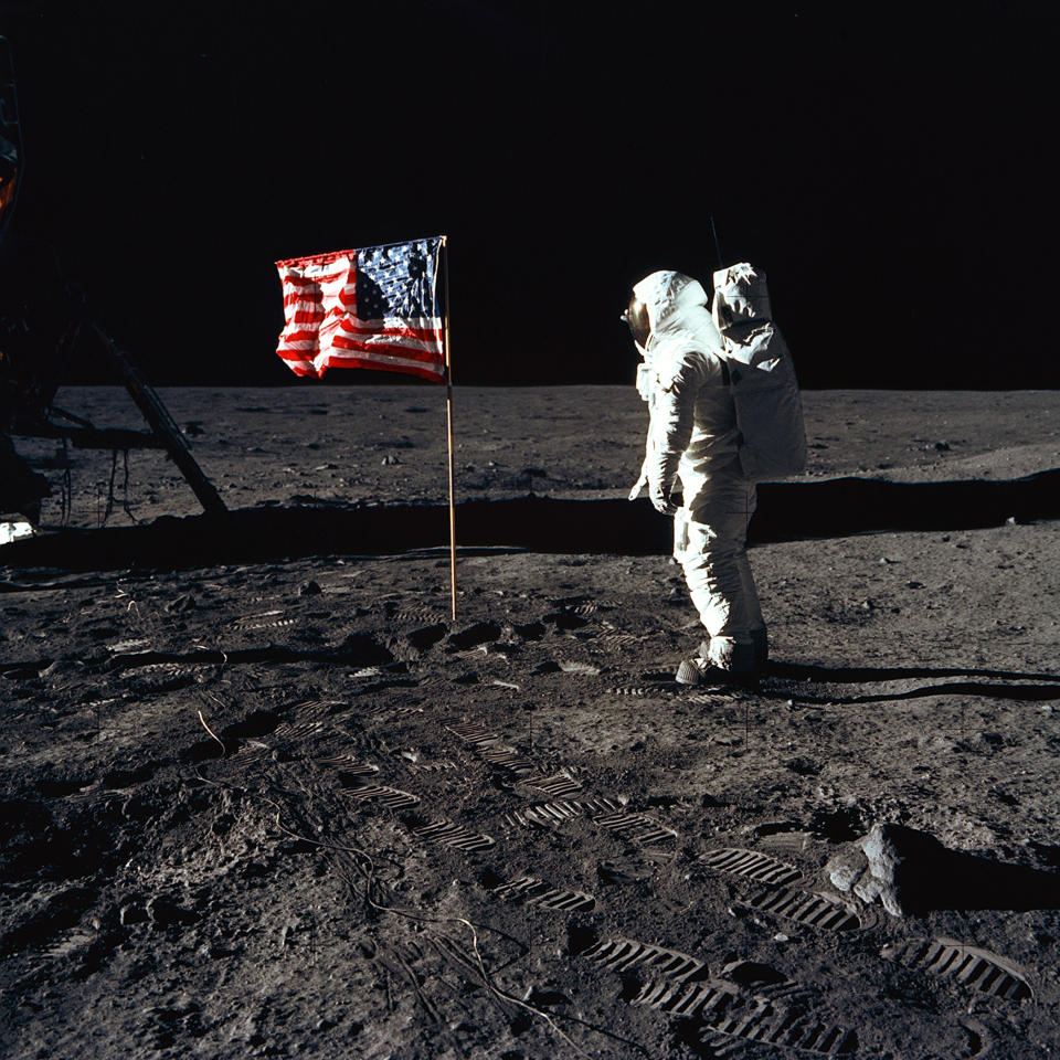 Astronaut Buzz Aldrin, lunar module pilot of the first lunar landing mission, poses for a photograph beside the deployed United States flag during an Apollo 11 Extravehicular Activity (EVA) on the lunar surface on July 20, 1969. The Lunar Module (LM) is on the left, and the footprints of the astronauts are clearly visible in the soil of the Moon. Astronaut Neil A. Armstrong, commander, took this picture with a 70mm Hasselblad lunar surface camera. While astronauts Armstrong and Aldrin descended in the LM, the "Eagle", to explore the Sea of Tranquility region of the Moon, astronaut Michael Collins, command module pilot, remained with the Command and Service Modules (CSM) "Columbia" in lunar-orbit. (Photo: NASA)