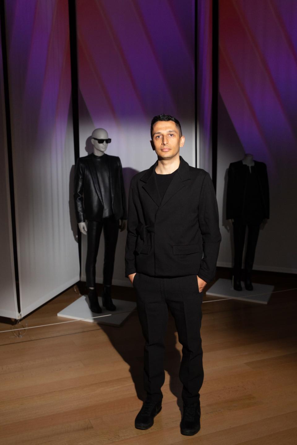 <h1 class="title">Rad Hourani poses with his work.</h1><cite class="credit">Photo: Michael Blanchard</cite>