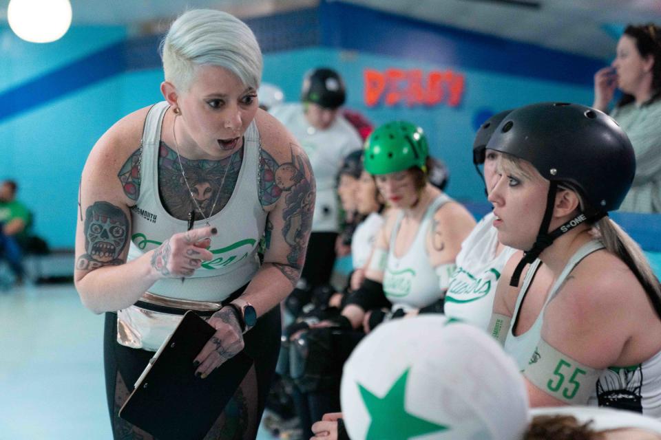 Cassandra Novack, also known as Scarlett O'Scare Ya, goes down the line of players after a change during Saturday's bout against the Salina Sirens.