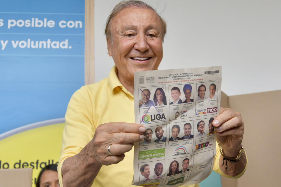 Rodolfo Hernandez, presidential candidate with the Anti-corruption Governors League, shows his ballot before voting in presidential elections in Bucaramanga, Colombia, Sunday, May 29, 2022. (AP Photo/Mauricio Pinzon)