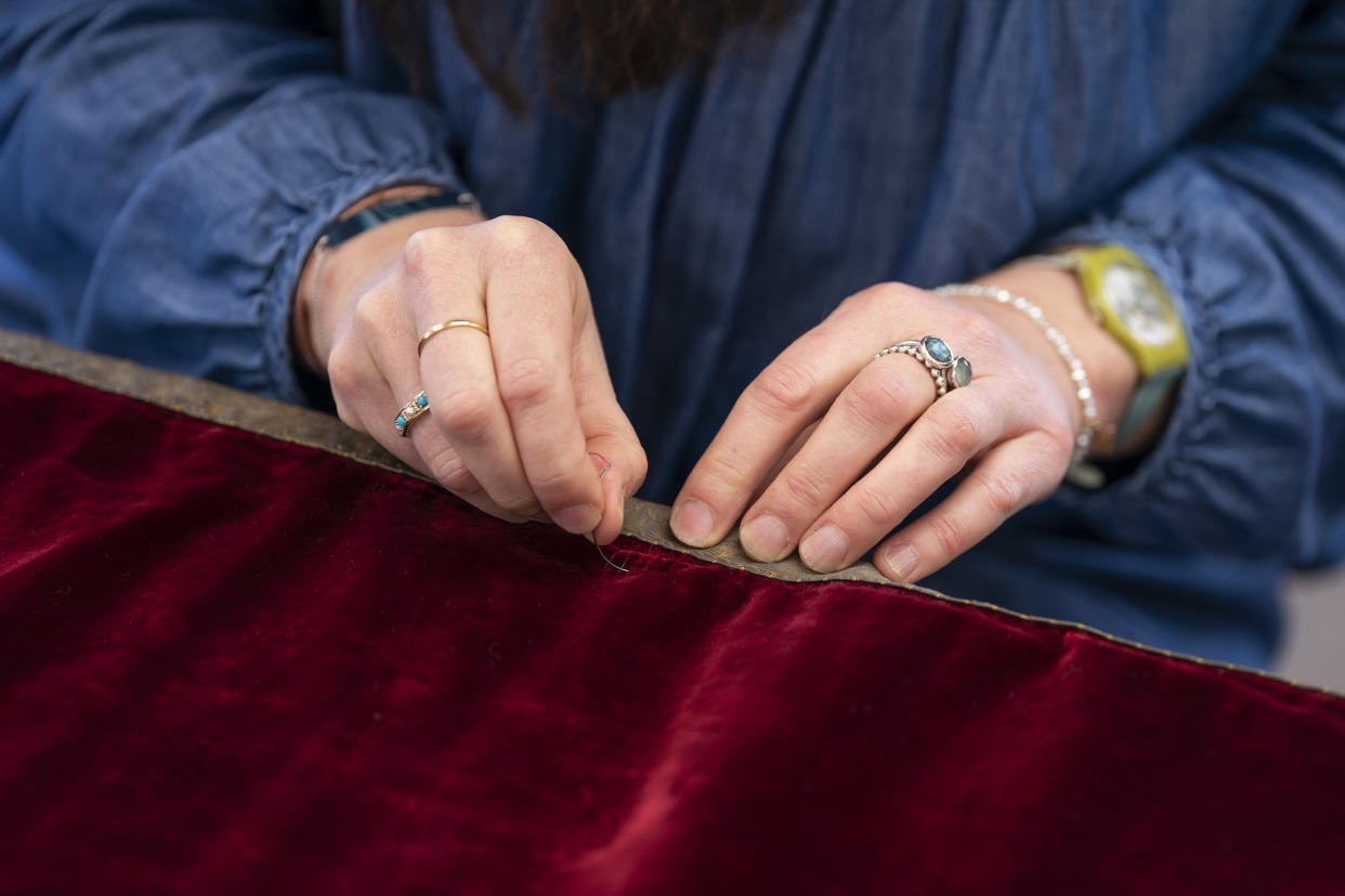 Work is carried out on King Charles III's Robe of State, which he will wear at his coronation on May 6, by a member of the Royal School of Needlework, at Hampton Court Palace, in East Molesey. Picture date: Monday February 27, 2023. (Kirsty O'Connor / PA Wire)