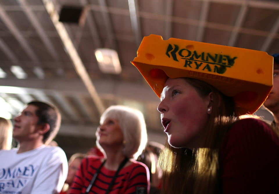 A supporter wears a Cheesehead hat as Republican presidential candidate, former Massachusetts Gov. Mitt Romney speaks during a campaign rally at the Wisconsin Products Pavilion at State Fair Park on November 2, 2012 in West Allis, Wisconsin. (Photo by Justin Sullivan/Getty Images)