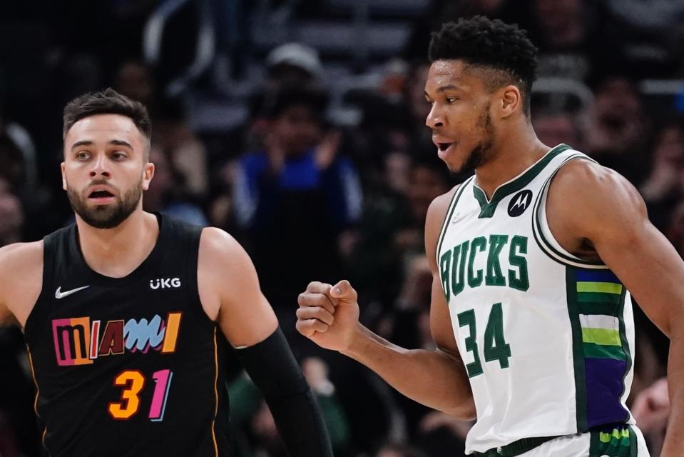 Milwaukee Bucks' Giannis Antetokounmpo reacts in front of Miami Heat's Max Strus after making a basket and being fouled during the first half of an NBA basketball game Wednesday, March 2, 2022, in Milwaukee . (AP Photo/Morry Gash)