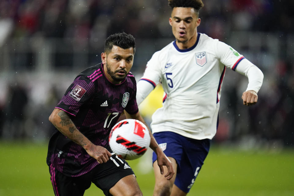 Mexico's Jesus Corona, left, and United States' Antonee Robinson compete for posessio during the second half of a FIFA World Cup qualifying soccer match, Friday, Nov. 12, 2021, in Cincinnati. The U.S. won 2-0. (AP Photo/Julio Cortez)