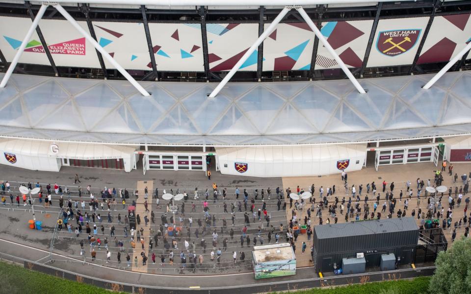 People queue outside an NHS Vaccination Clinic at West Ham's London Stadium in Stratford, east London.  - Dominic Lipinski/PA