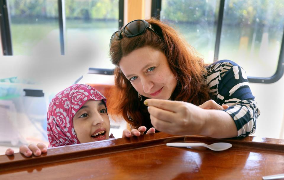 Kaeti Stoss, from RIT, shows Salma Obad a small bug collected from the Genesee River. Fifth-graders from the Rochester City School District during took a ride on the river as part of their science curriculum. All 5th-graders in the district will get the opportunity to have the science class during the school year. There will be more classes doing the science cruise in the spring.