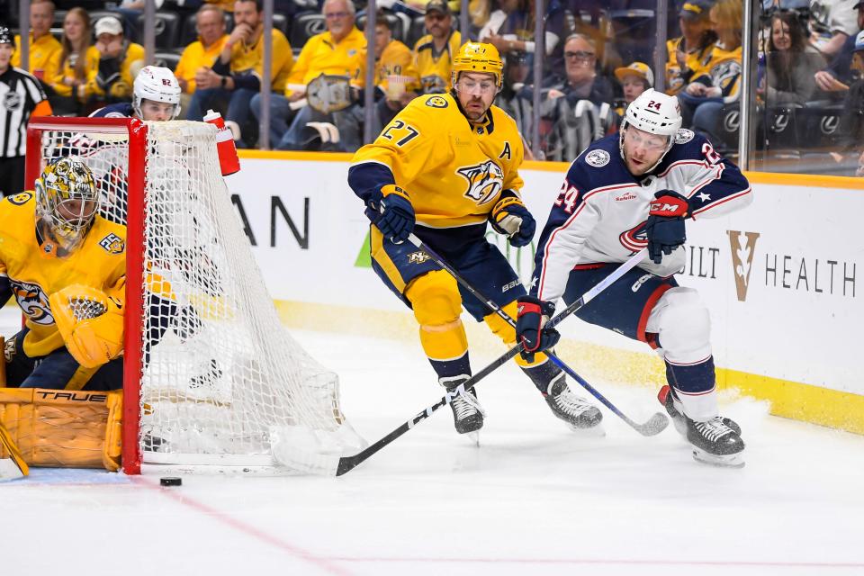 Apr 13, 2024; Nashville, Tennessee, USA; Columbus Blue Jackets right wing Mathieu Olivier (24) takes a shot on goal against the Nashville Predators during the second period at Bridgestone Arena. Mandatory Credit: Steve Roberts-USA TODAY Sports