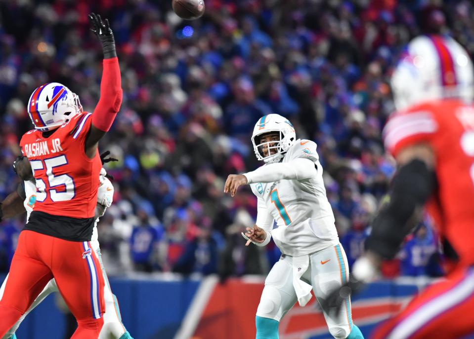 Dec 17, 2022; Orchard Park, New York, USA; Miami Dolphins quarterback Tua Tagovailoa (1) throws a pass as Buffalo Bills defensive end Boogie Basham (55) rushes in the first quarter at Highmark Stadium. Mandatory Credit: Mark Konezny-USA TODAY Sports