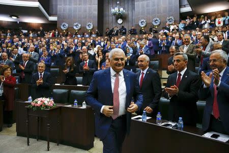 Turkey's new Prime Minister Binali Yildrim is greeted by members of parliament from his ruling AK Party (AKP) as he arrives for a meeting at the Turkish parliament in Ankara, Turkey, May 24, 2016. Reuters/Umit Bektas