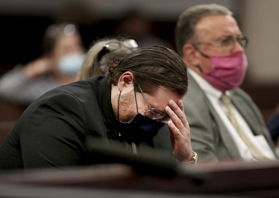 David Raubenolt, center, reacts as his brother shares a victim impact statement during Cameron Herrin's sentencing hearing on Thursday, April 8, 2021, at the Hillsborough County Edgecomb Courthouse before 13th Judicial Circuit Court Judge Christopher Nash in downtown Tampa, Fla. Herrin was sentenced to 24 years in prison for killing Raubenolt's wife and young daughter in a 2018 traffic crash. (Douglas R. Clifford/Tampa Bay Times via AP)