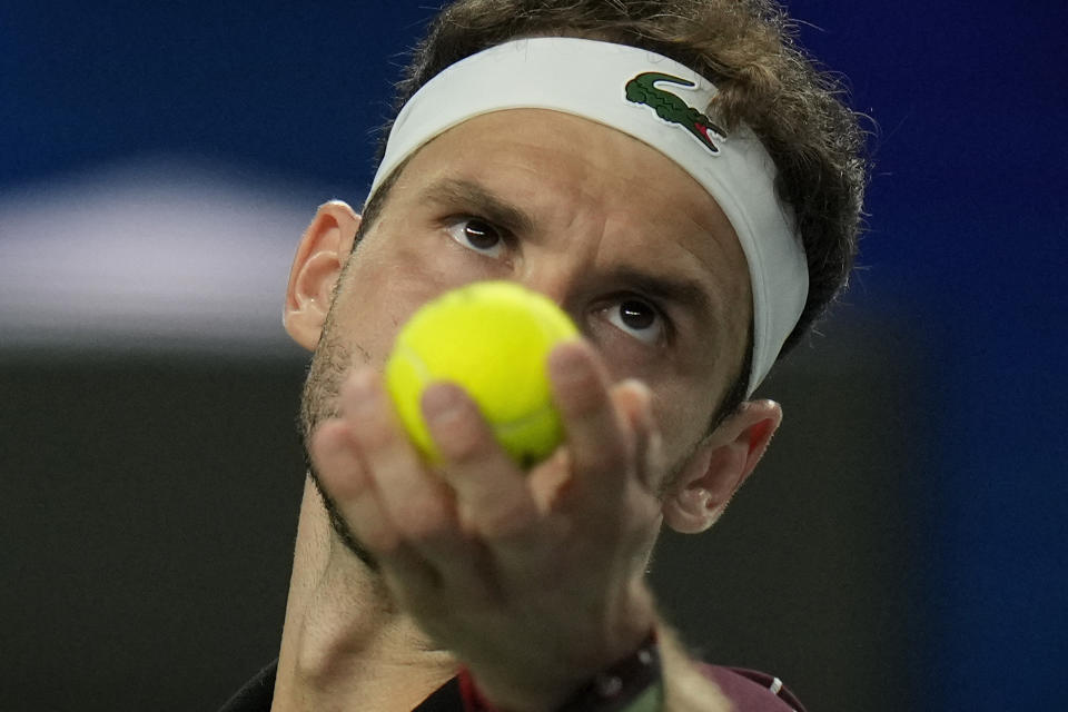 Grigor Dimitrov of Bulgaria serves against Carlos Alcaraz of Spain during the 4th round of the men's singles match in the Shanghai Masters tennis tournament at Qizhong Forest Sports City Tennis Center in Shanghai, China, Wednesday, Oct. 11, 2023. (AP Photo/Andy Wong)