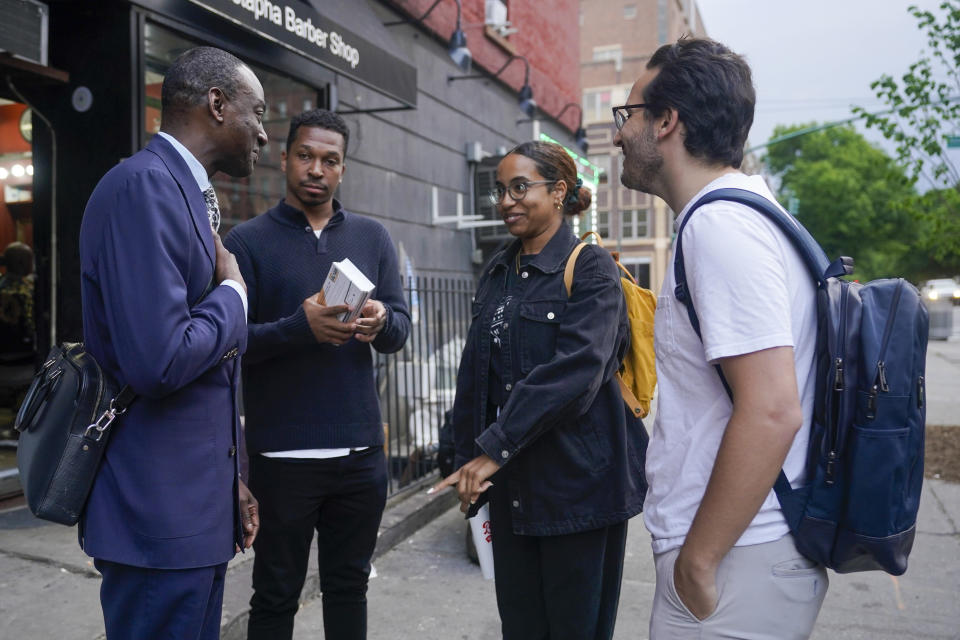 New York City Council candidate Yusef Salaam, left, and his campaign manager Jordan Wright, second from left, talk to Harlem residents while canvasing in the neighborhood, Wednesday, May 24, 2023, in New York. Salaam is one of three candidates in a competitive June 27 Democratic primary. With early voting already begun, he faces two seasoned political veterans: New York Assembly members Al Taylor, 65, and Inez Dickens, 73, who previously represented Harlem on the City Council. (AP Photo/Mary Altaffer)