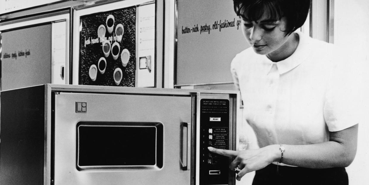 when was the microwave invented, woman demonstrates microwave oven