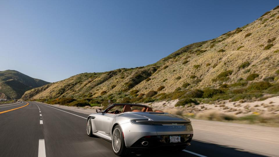 2024 aston martin db12 volante driving on a road