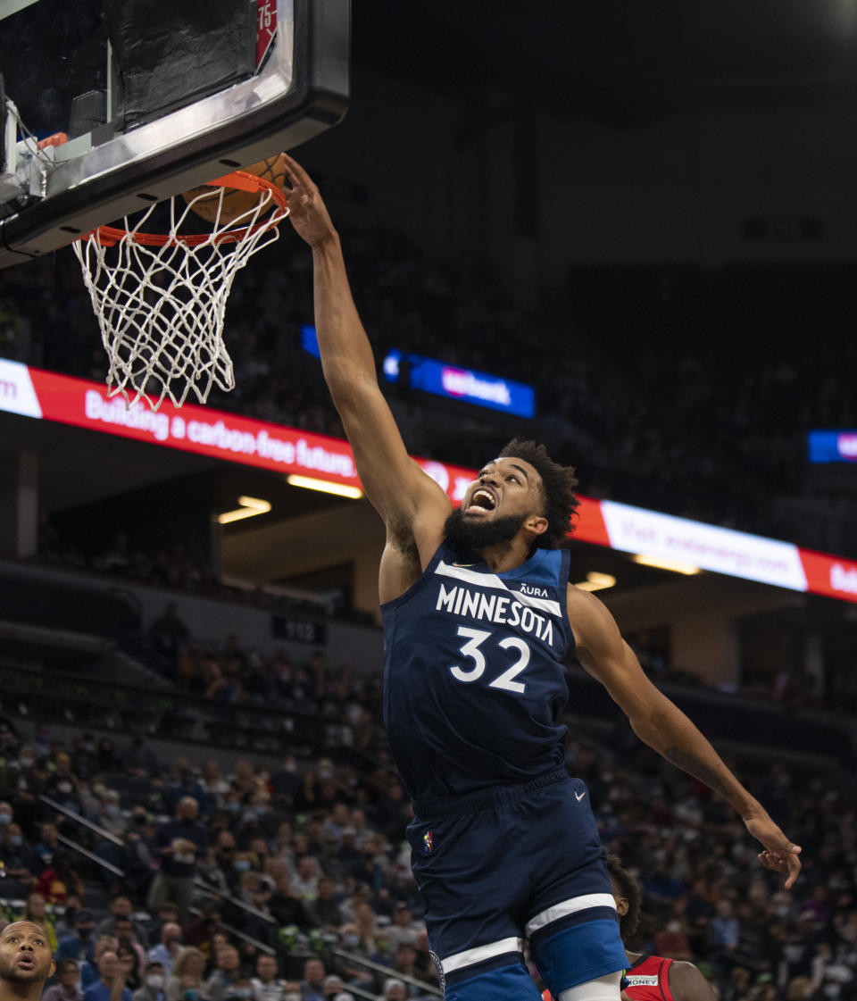 Minnesota Timberwolves center Karl-Anthony Towns dunks against the Houston Rockets during the first half of an NBA basketball game Wednesday, Oct. 20, 2021, in Minneapolis. (Jeff Wheeler/Star Tribune via AP)